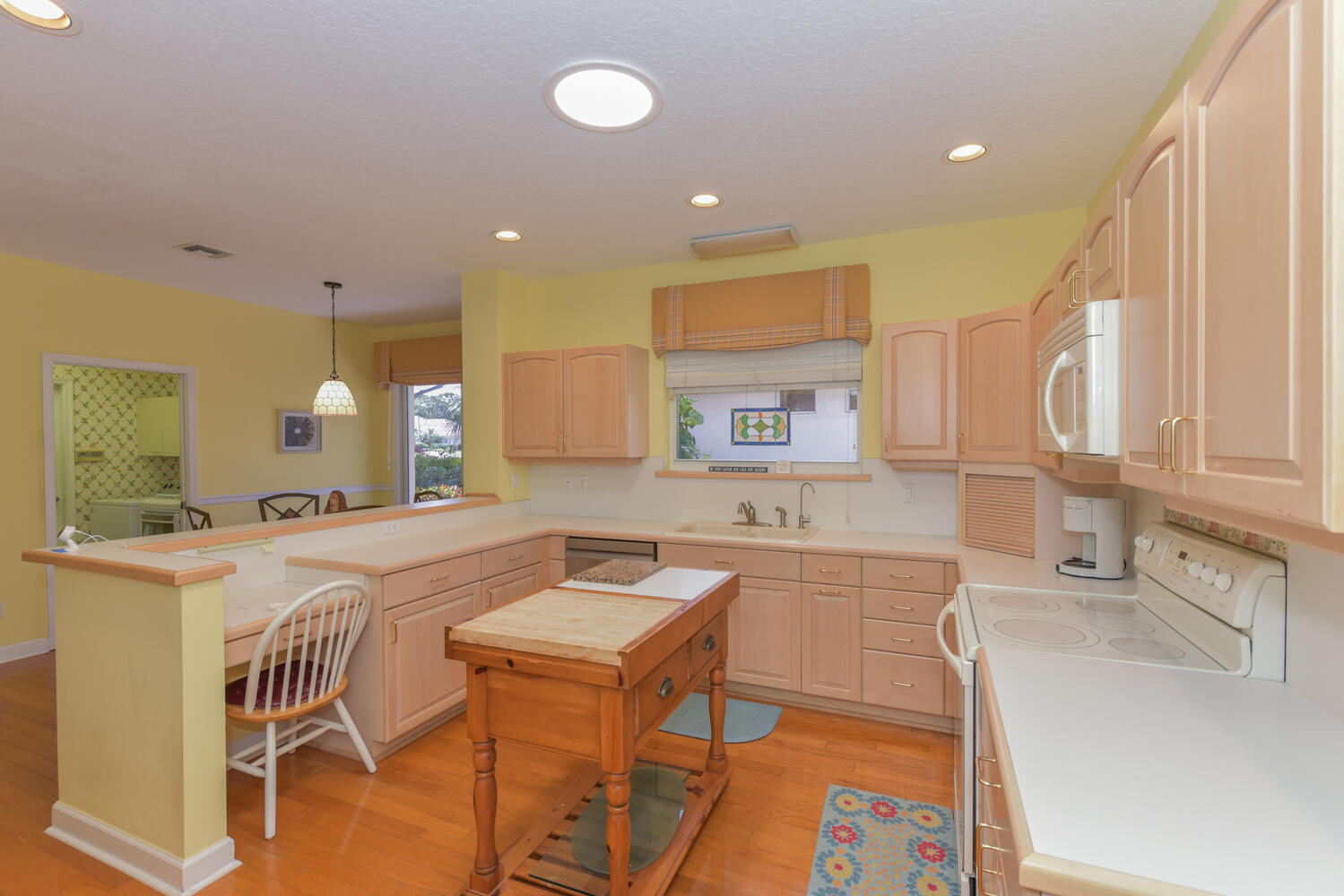 3510 Southeast Cambridge Drive Stuart, FL 34997 - Photo 17 of 54 a large kitchen with a table and chairs in it