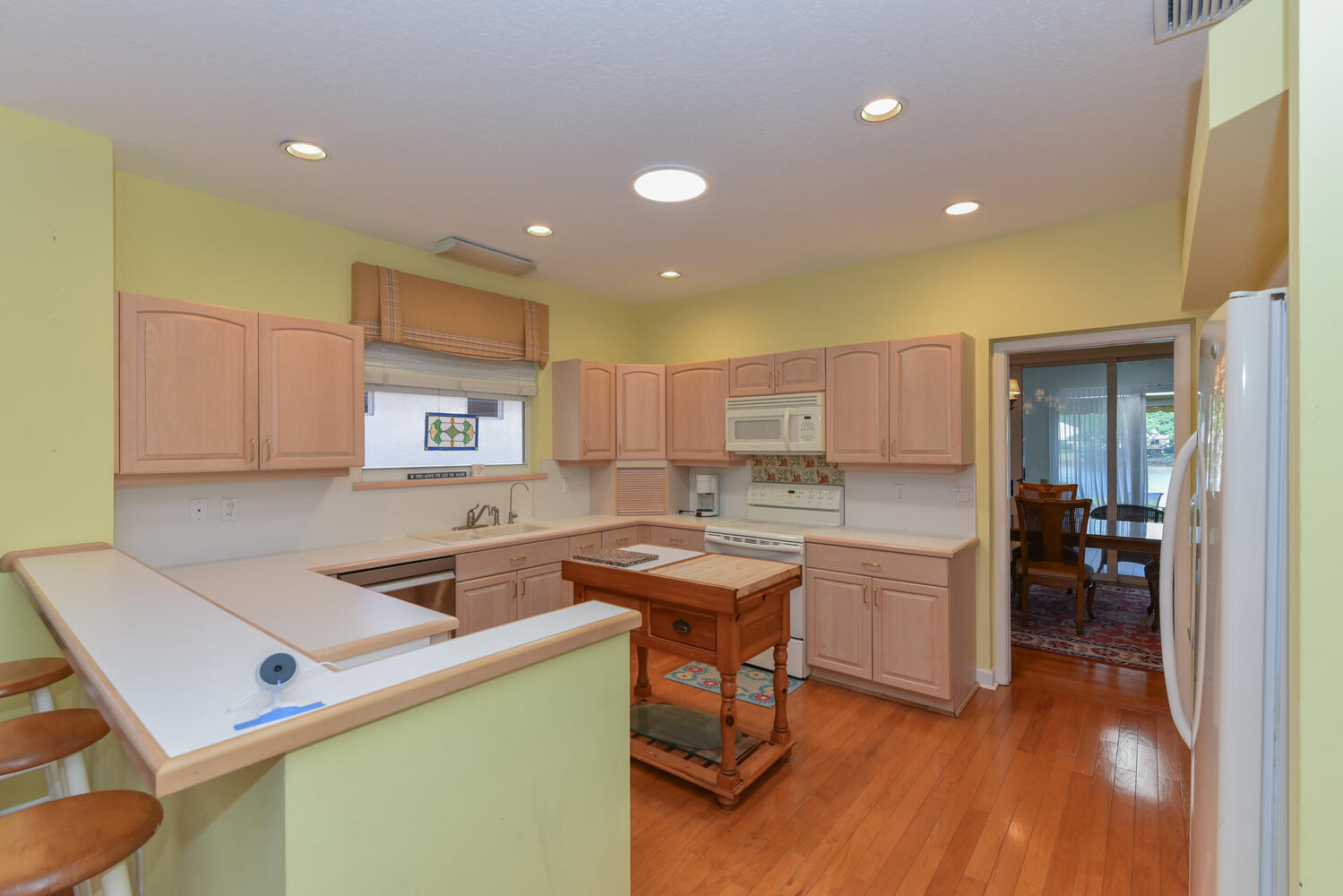 3510 Southeast Cambridge Drive Stuart, FL 34997 - Photo 18 of 54 a kitchen with a sink cabinets and wooden floor
