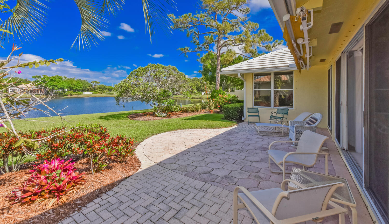 3510 Southeast Cambridge Drive Stuart, FL 34997 - Photo 25 of 54 a front view of a house with a yard