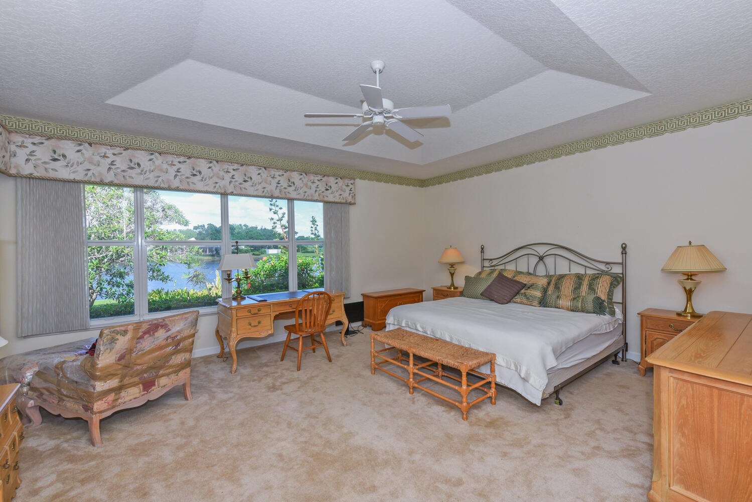 3510 Southeast Cambridge Drive Stuart, FL 34997 - Photo 30 of 54 a bedroom with furniture and a large window