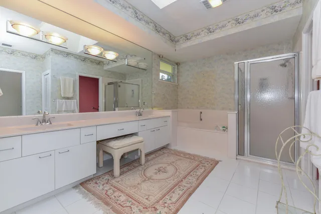 a bathroom with a shower sink vanity mirror and toilet