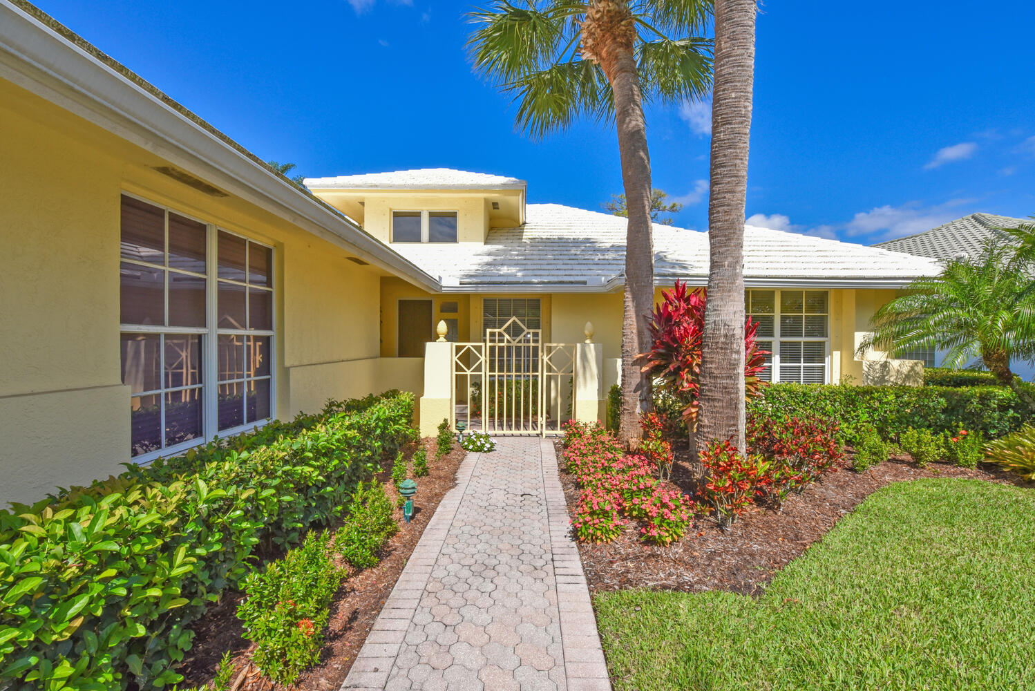 3510 Southeast Cambridge Drive Stuart, FL 34997 - Photo 7 of 54 a front view of a house with a garden