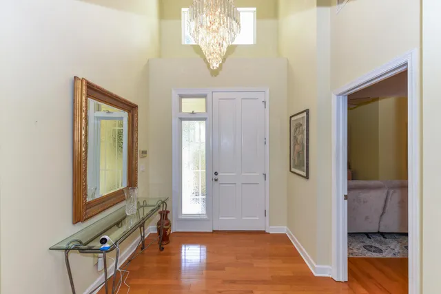 a dining room with furniture and a chandelier