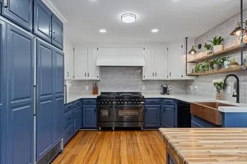 a kitchen with wooden cabinets and center island