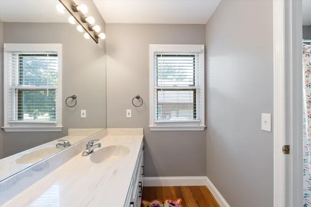 a view of a room with wooden floor