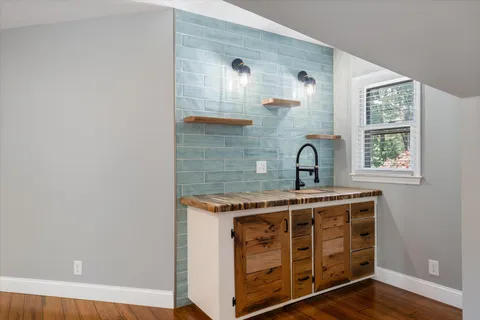 a bathroom with a bathtub and next to a window