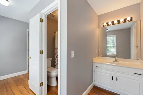 a view of a roof deck with table and chairs and wooden floor