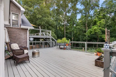 a view of a house with a big yard and large trees