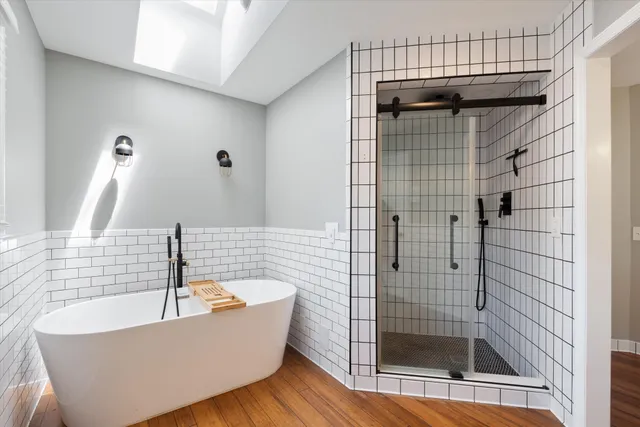 a bathroom with a bathtub and shower