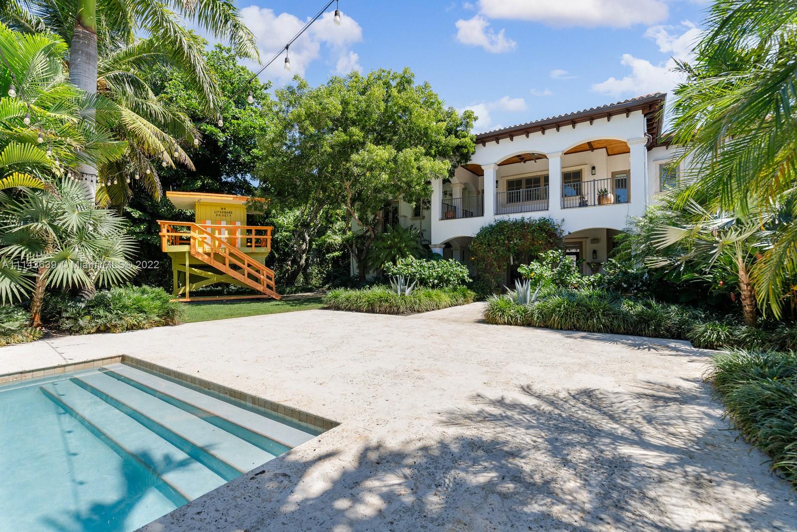 8230 Southwest 53rd Avenue Miami, FL 33143 - Photo 29 of 34 a front view of a house with a yard and trees