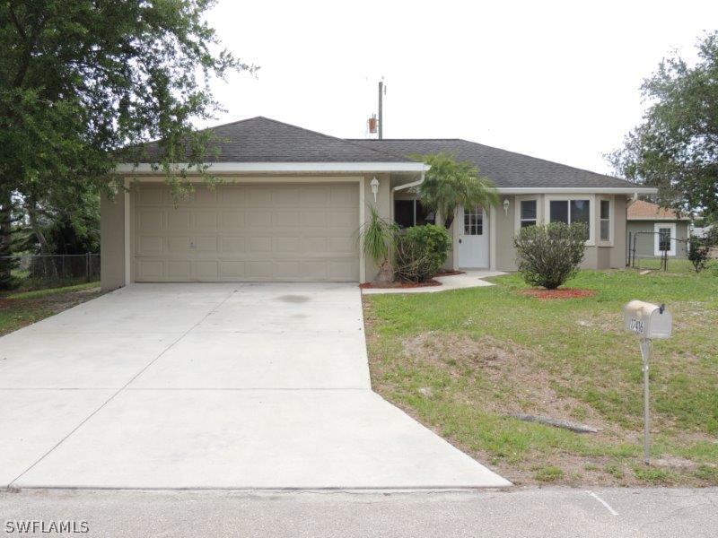 17416 Kentucky Road Fort Myers, FL 33967 - Photo 1 of 13 a front view of a house with garden
