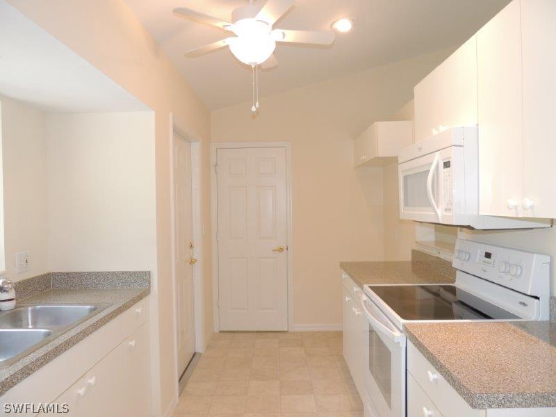 17416 Kentucky Road Fort Myers, FL 33967 - Photo 2 of 13 a kitchen that has a sink a stove and a refrigerator