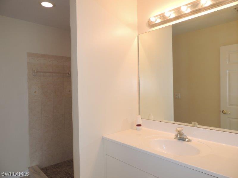 17416 Kentucky Road Fort Myers, FL 33967 - Photo 7 of 13 a bathroom with a sink and a mirror