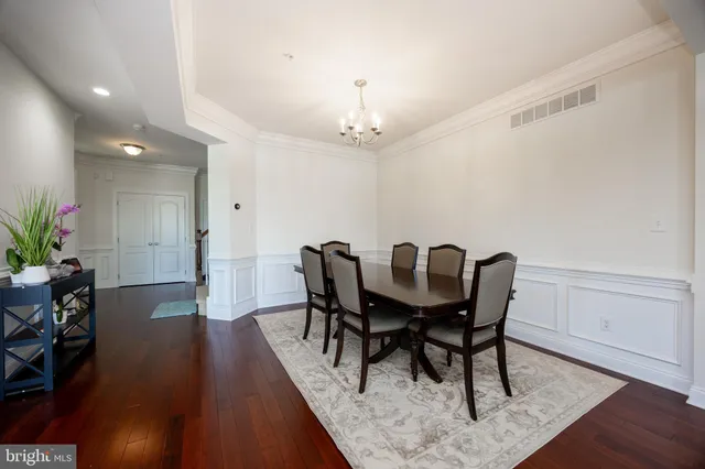a view of a a dining room with furniture window and wooden floor