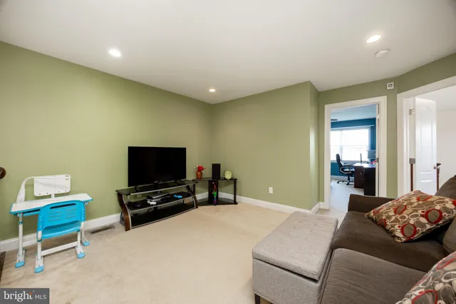 a bedroom with furniture and a flat screen tv