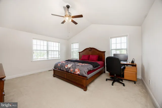 a bedroom with a bed window and a desk