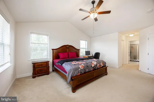 a bedroom with a bed dresser and a window