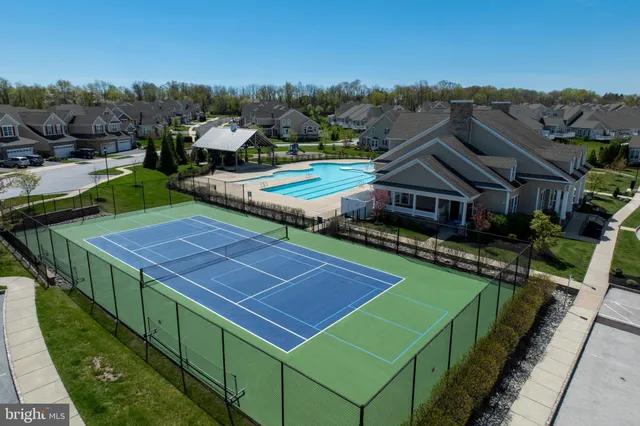 an aerial view of a house with swimming pool and garden