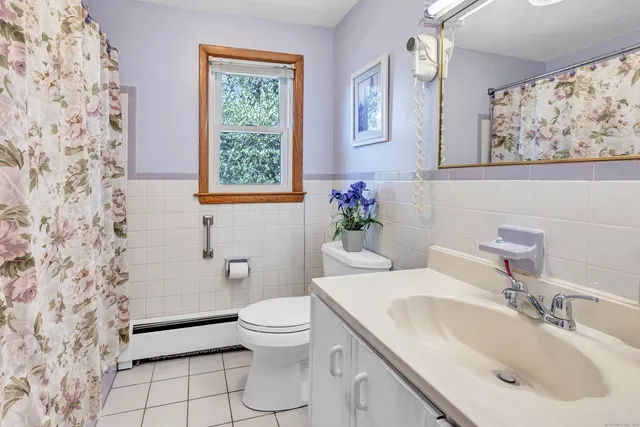 a bathroom with a sink mirror and toilet