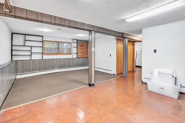 a view of a livingroom with wooden floor and windows