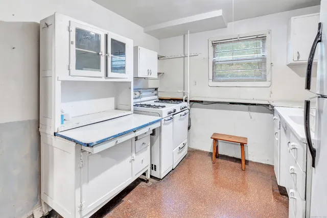 a kitchen with a stove a sink and a refrigerator