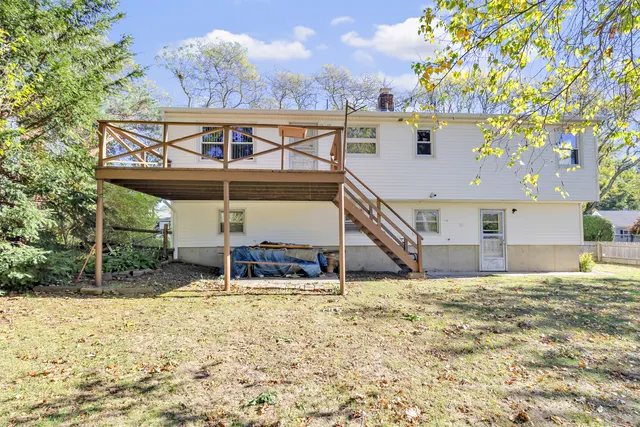 a view of a chairs and table in the backyard