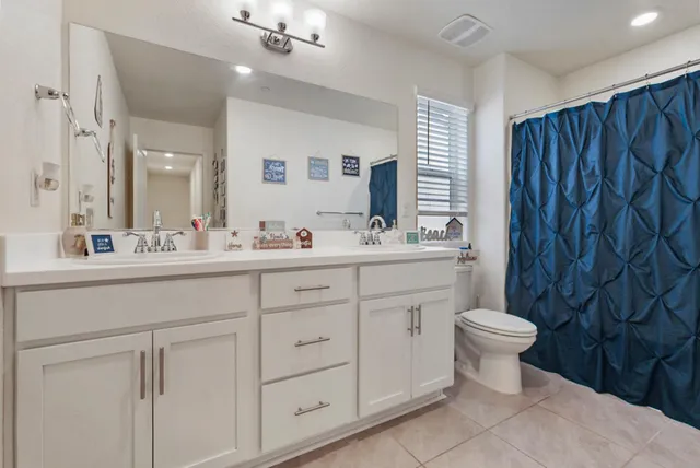 a bathroom with a sink toilet a mirror and shower