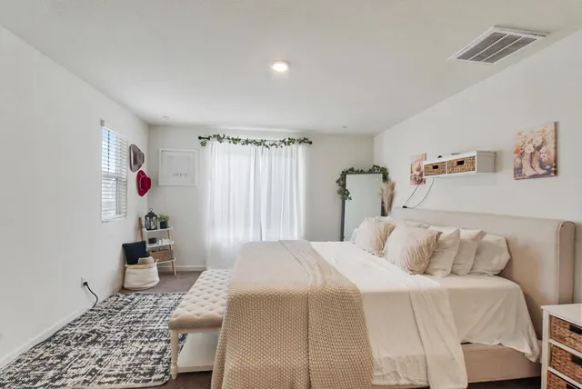 a bedroom with a bed and a window