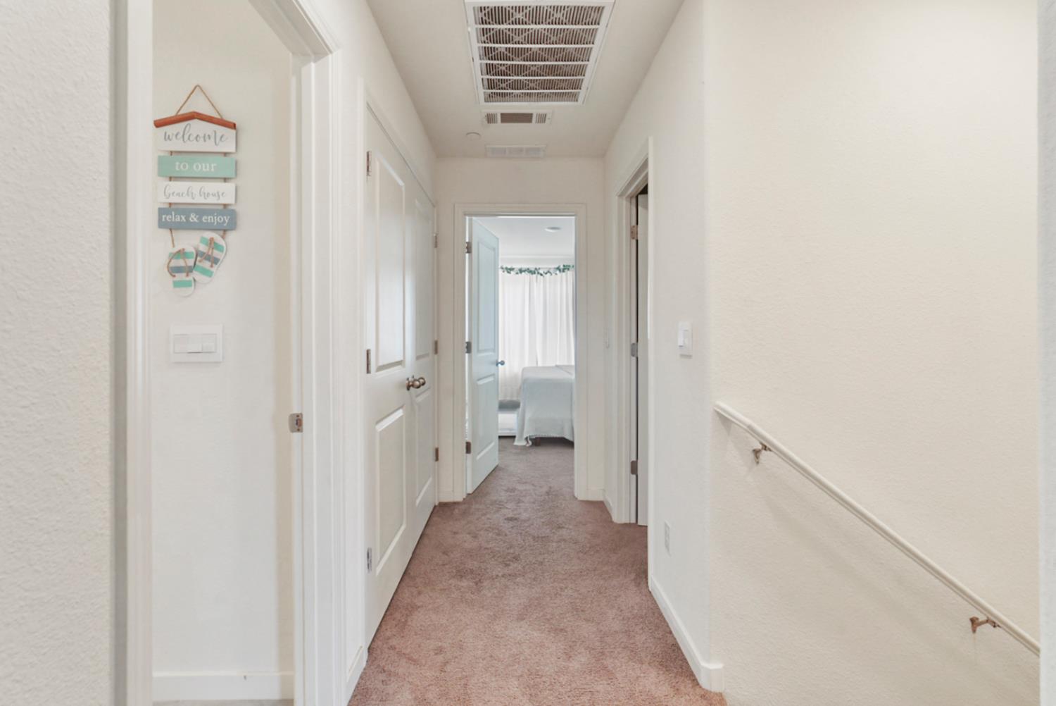 377 Shafer Avenue Merced, CA 95348 - Photo 22 of 36 a view of a hallway with white walls and a white door