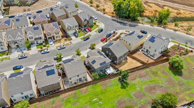 an aerial view of a house with a swimming pool yard and outdoor seating