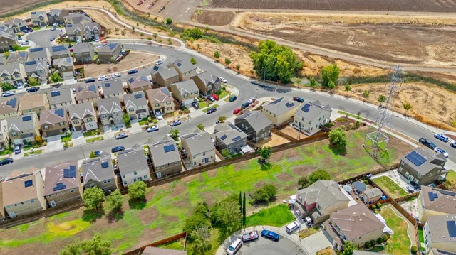 an aerial view of residential house with outdoor space and seating area