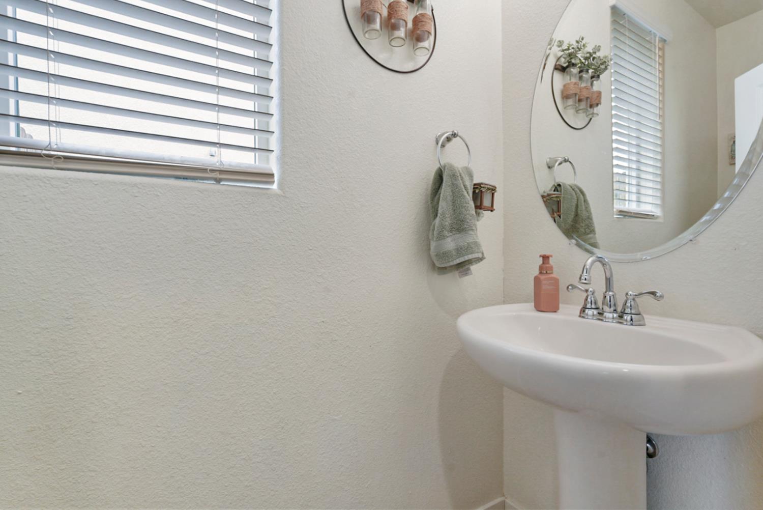 377 Shafer Avenue Merced, CA 95348 - Photo 4 of 36 a bathroom with a sink and a mirror