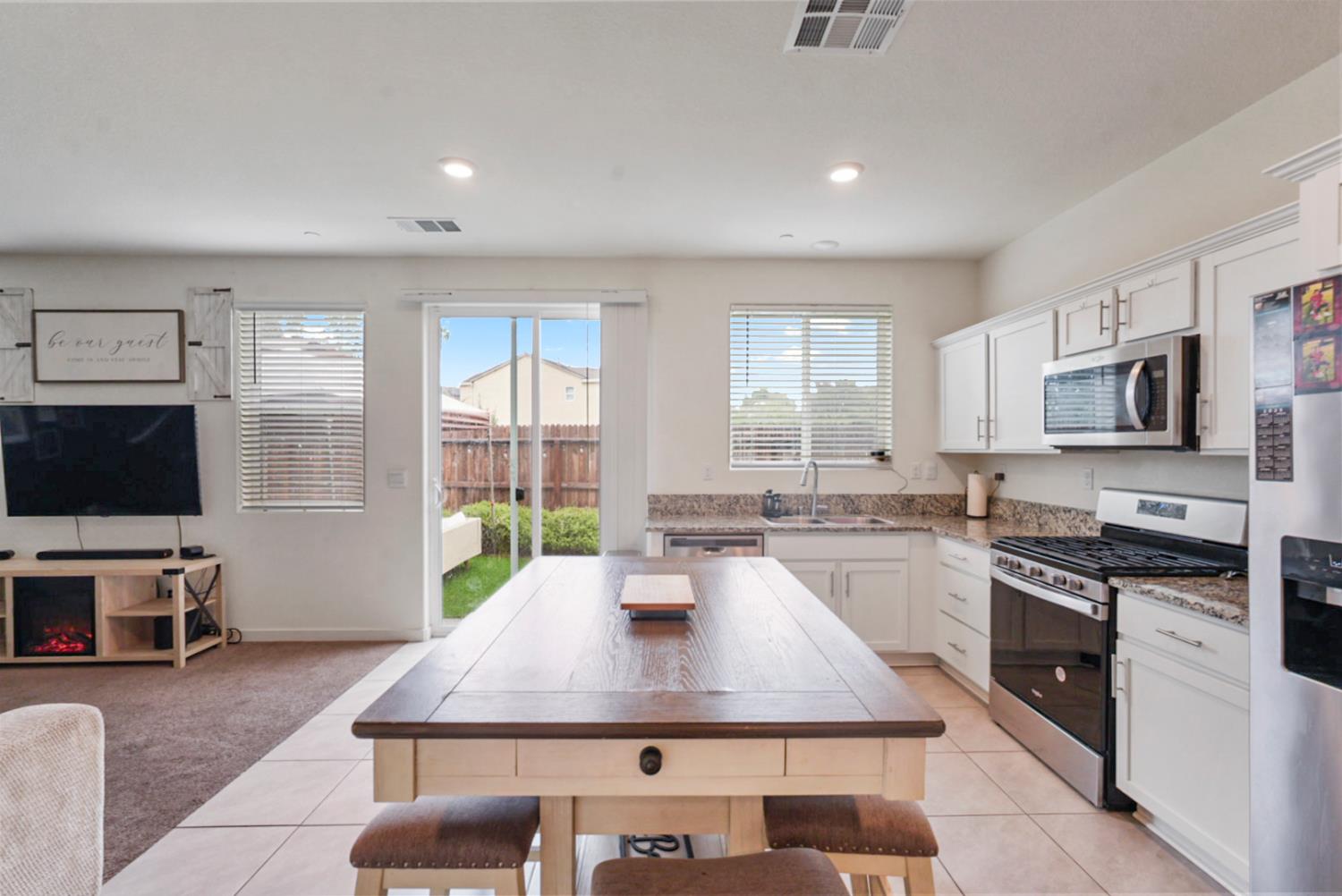 377 Shafer Avenue Merced, CA 95348 - Photo 10 of 36 a kitchen with sink stove and microwave