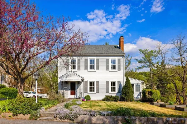a front view of a house with a garden