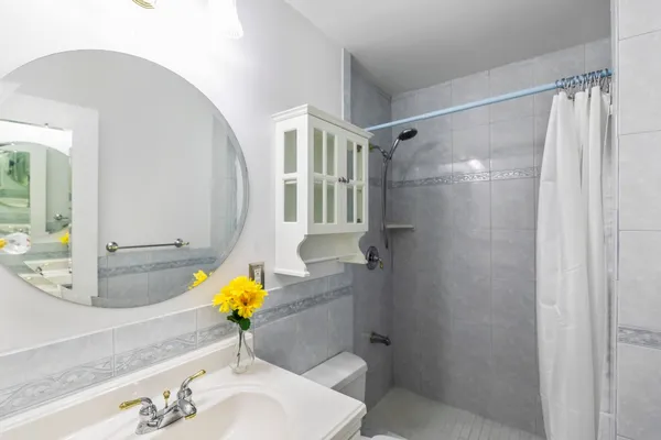 a bathroom with a sink toilet and shower