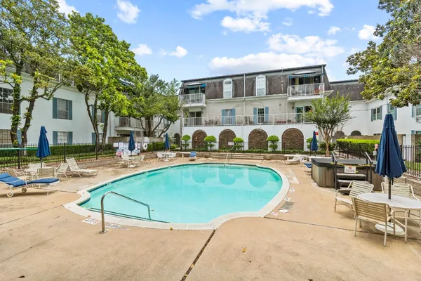 a swimming pool with outdoor seating and yard