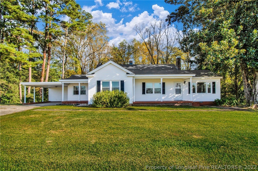 6474 Sisk Culbreth Road Godwin, NC 28344 - Photo 1 of 23 a front view of a house with a garden