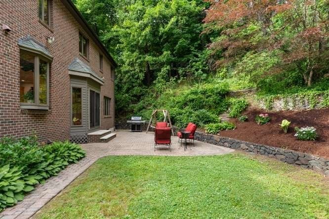 55 Meriam Street Lexington, MA 02420 - Photo 33 of 37 a view of a backyard with sitting area and garden
