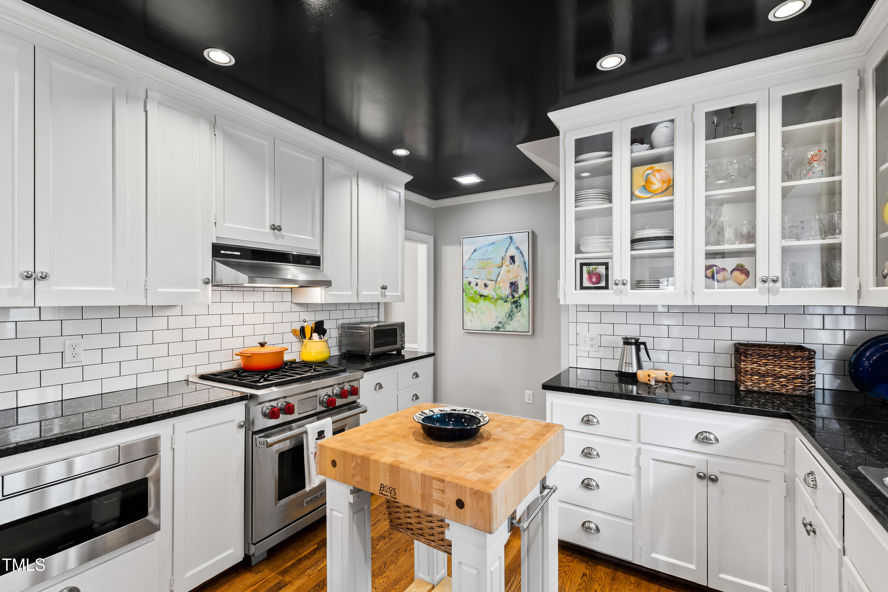 2147 Wake Drive Raleigh, NC 27608 - Photo 18 of 48 a kitchen with stainless steel appliances granite countertop a sink stove and cabinets