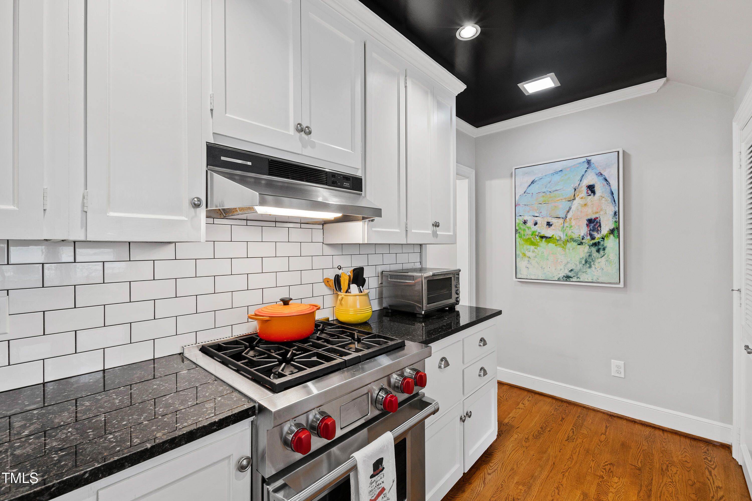 2147 Wake Drive Raleigh, NC 27608 - Photo 19 of 48 a stove top oven sitting inside of a kitchen
