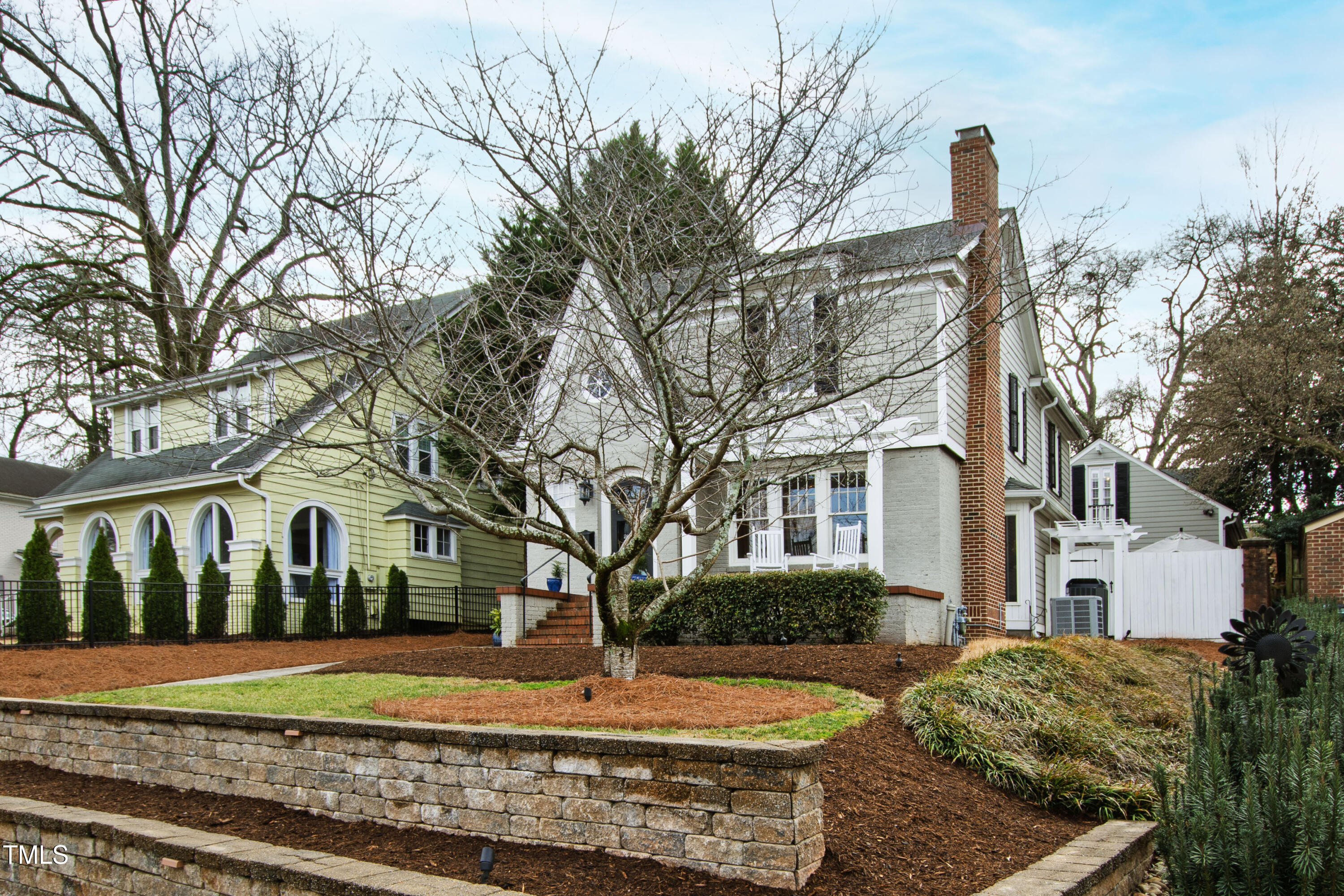 2147 Wake Drive Raleigh, NC 27608 - Photo 2 of 48 a view of a white house next to a yard with big trees