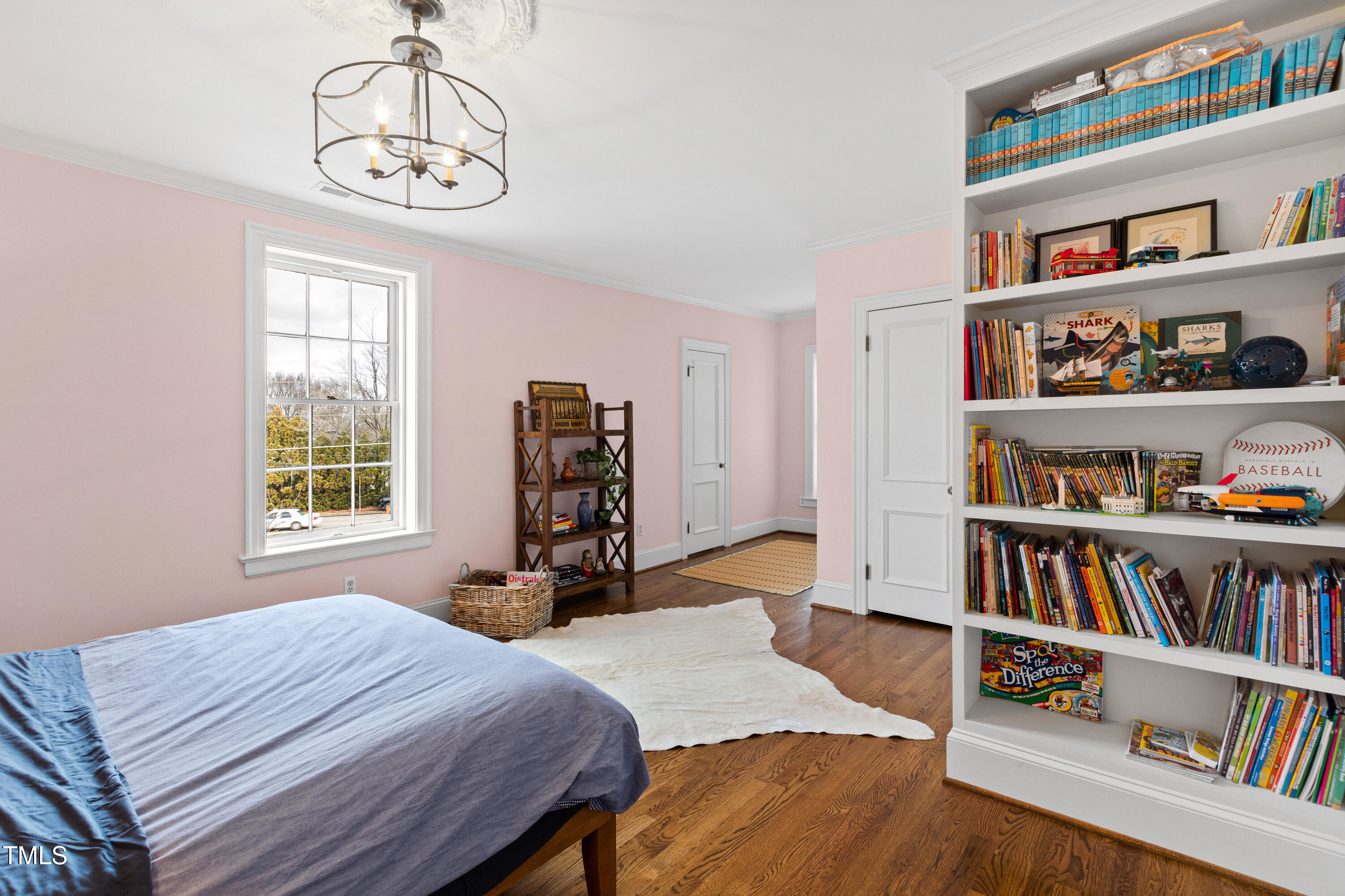 2147 Wake Drive Raleigh, NC 27608 - Photo 30 of 48 a bed room with a bed and a book shelf