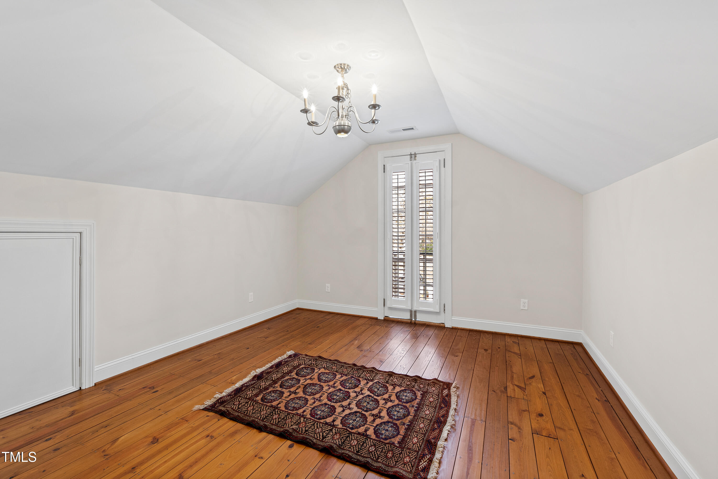 2147 Wake Drive Raleigh, NC 27608 - Photo 47 of 48 a view of a room with wooden floor and chandelier