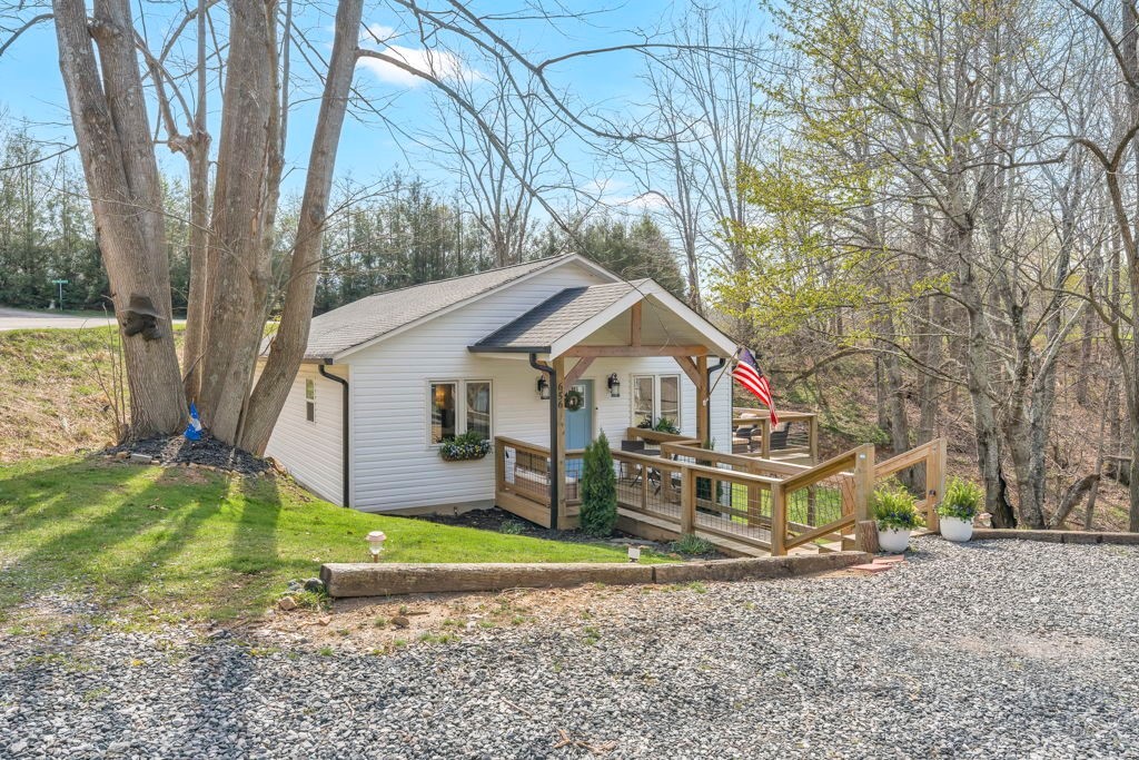 656 Mulatto Mountain Road West Jefferson, NC 28694 - Photo 5 of 35 a house that has a tree in front of the house