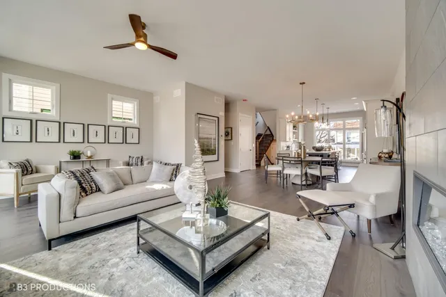 a living room with furniture a rug and a chandelier