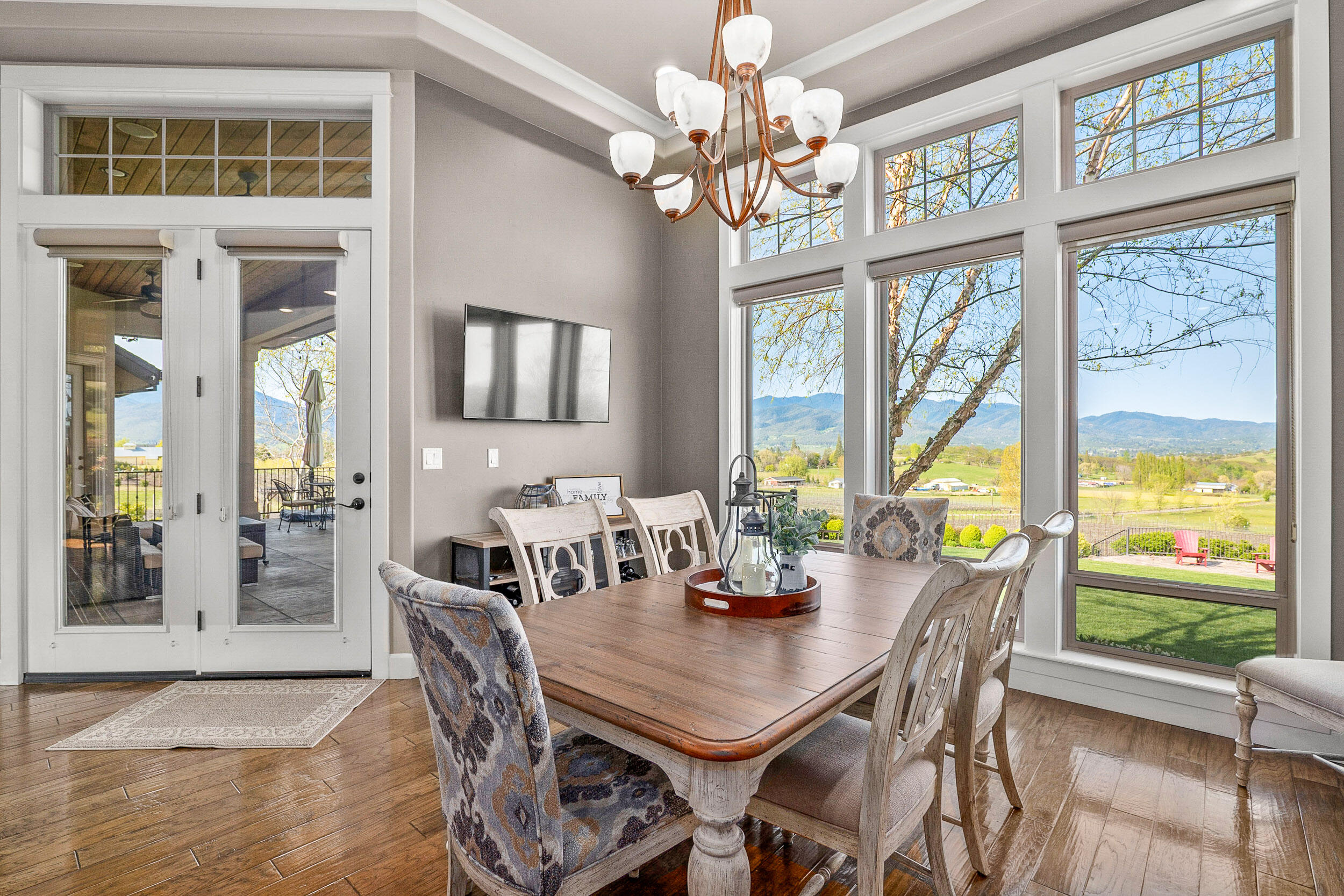 5709 Hughes Road Medford, OR 97504 - Photo 21 of 70 a view of a dining room with furniture large windows and wooden floor