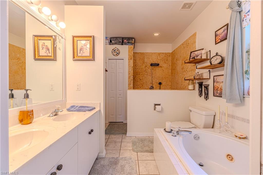 4065 10th Avenue Southeast Naples, FL 34117 - Photo 15 of 32 a bathroom with a tub sink and mirror