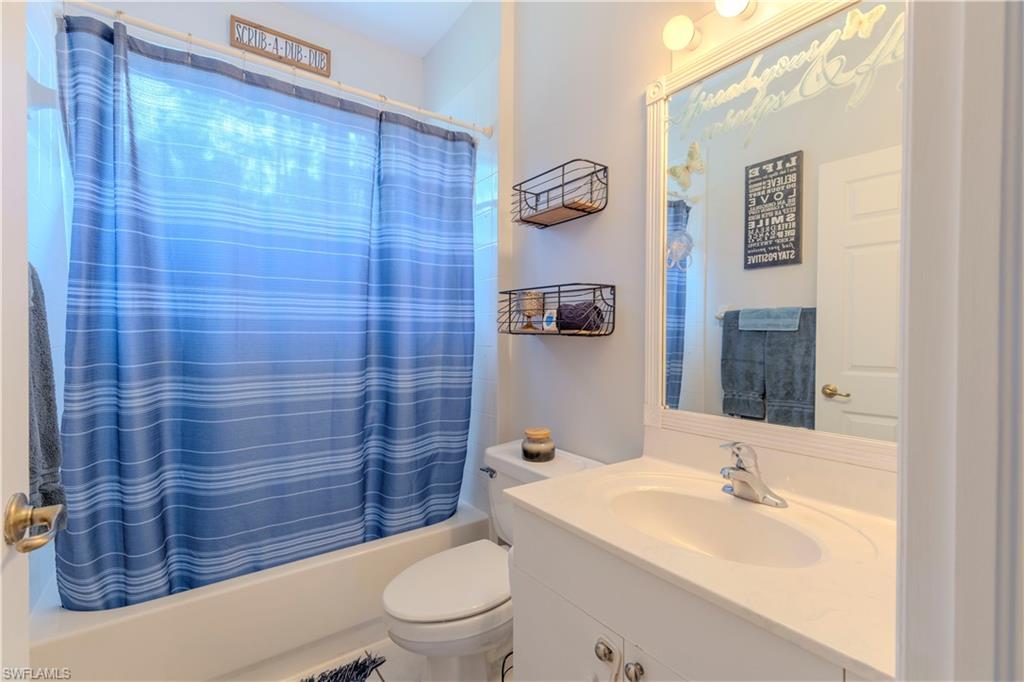 4065 10th Avenue Southeast Naples, FL 34117 - Photo 20 of 32 a bathroom with a toilet a sink and mirror