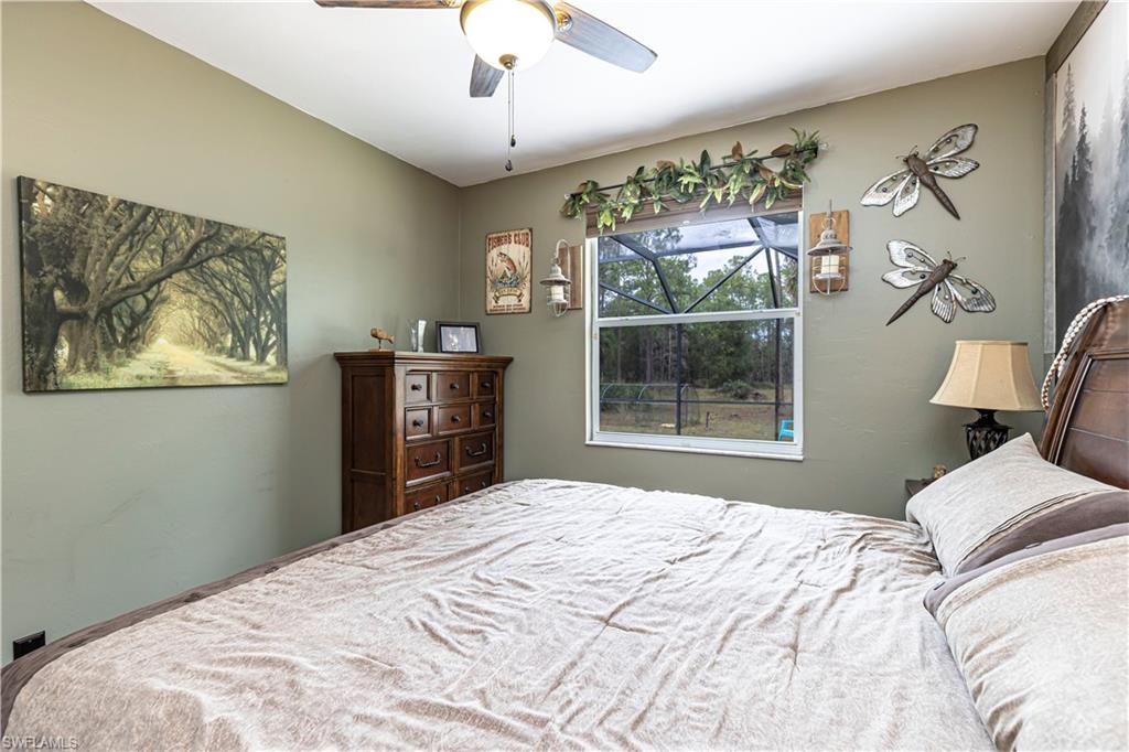 4065 10th Avenue Southeast Naples, FL 34117 - Photo 21 of 32 a bedroom with a large bed and a window