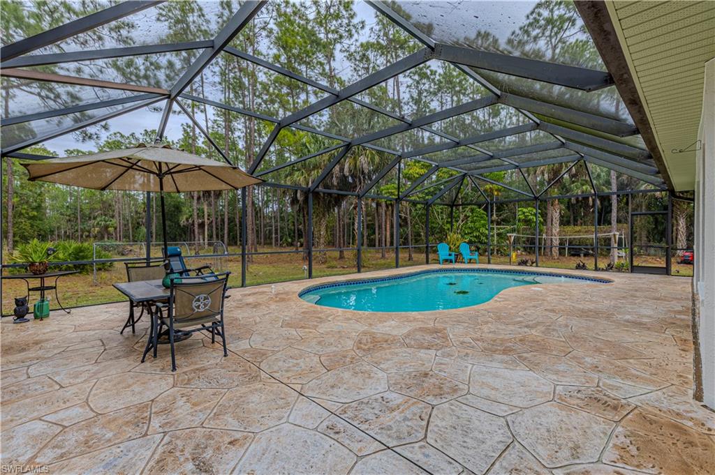 4065 10th Avenue Southeast Naples, FL 34117 - Photo 25 of 32 a view of a swimming pool with a patio